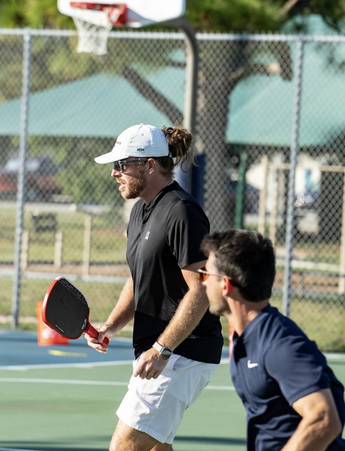 Two local pros moving up the court during a doubles demonstration.