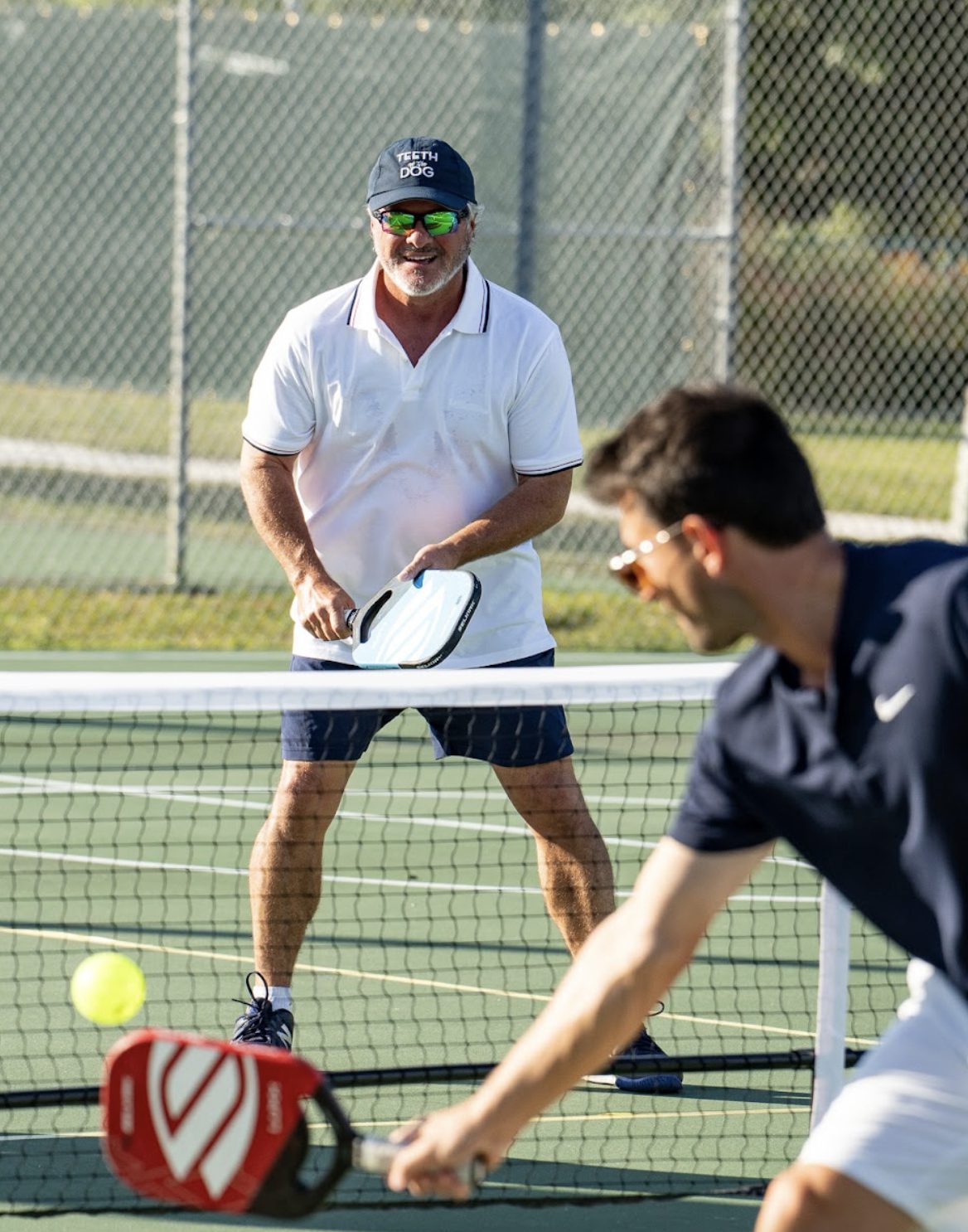 Two players trading shots at the net during the demonstration match.