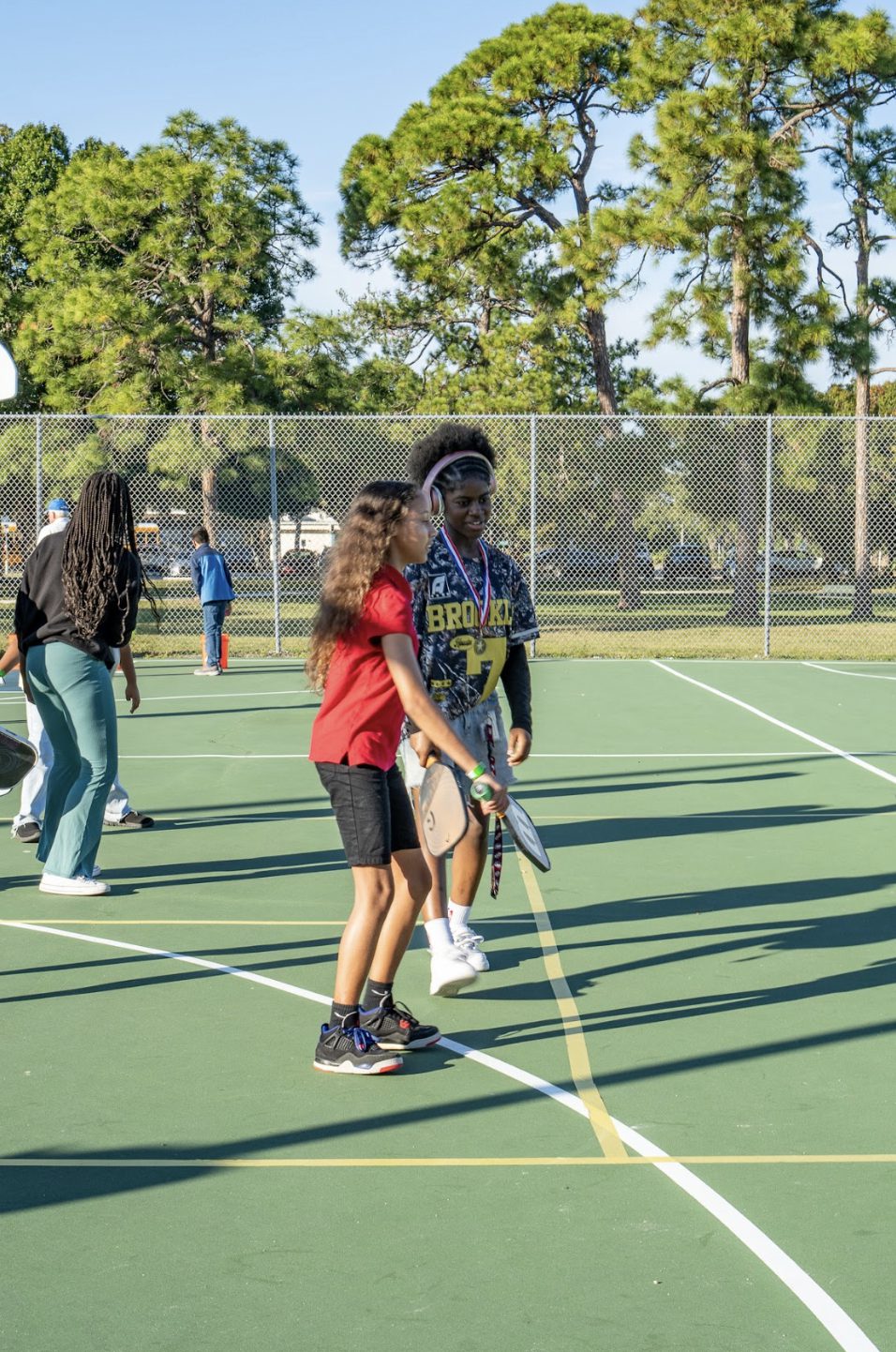 Two players facing off across the court during a station game.