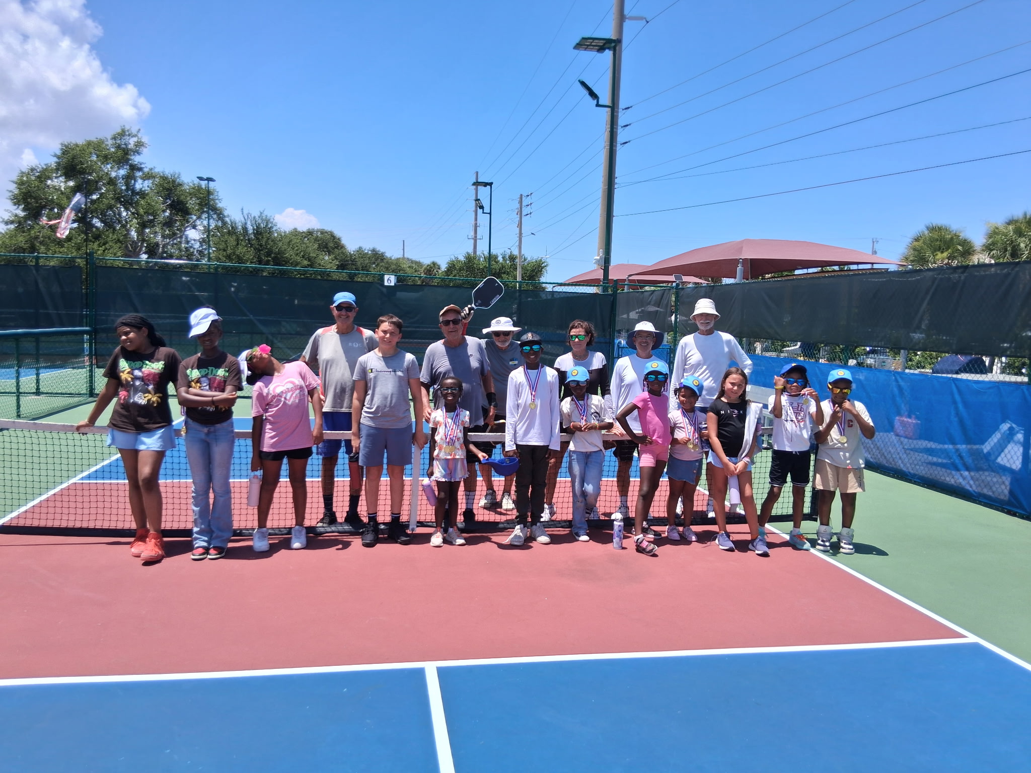 Campers and coaches lined up across the court for a group photo at the end of a session.